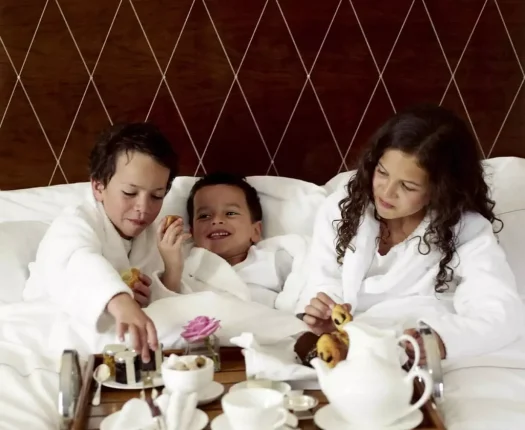 Discerning families staying in luxury interconnecting hotel suites at an exclusive five-star resort.