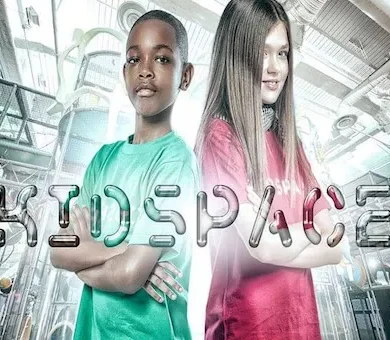Boy and girl standing in front of the KidSpace indoor play center logo background.