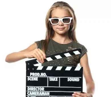 Young girl holding a film production clapperboard during an immersive experience film workshop.